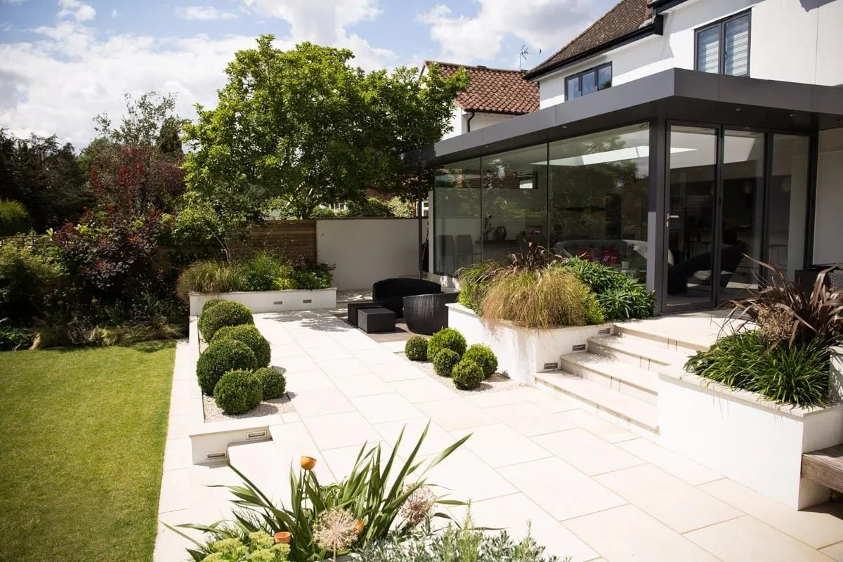 Landscaped garden with paved patio and modern rear extension, London